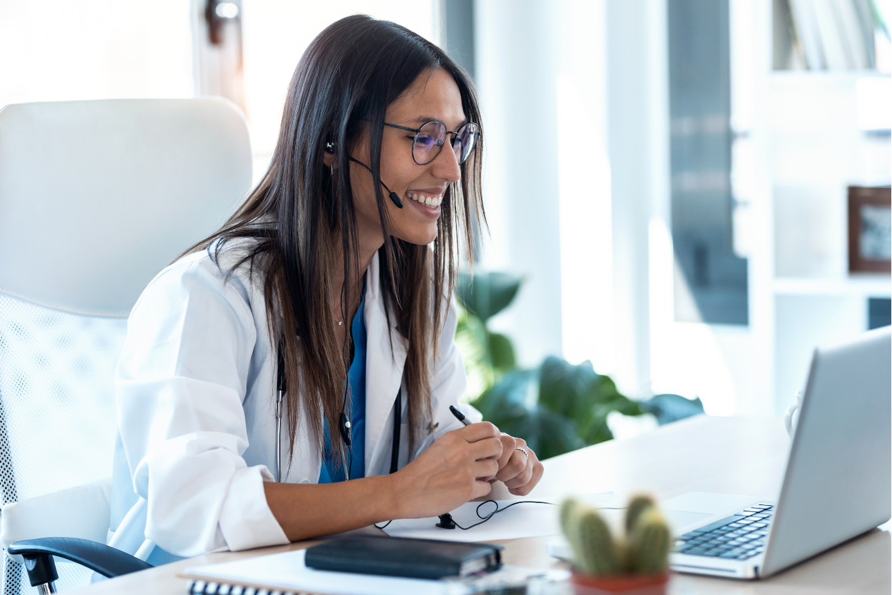 Female doctor conducting virtual consultation via laptop in a telehealth session