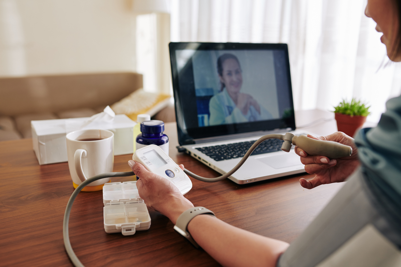 Woman using digital device at home for remote patient monitoring services