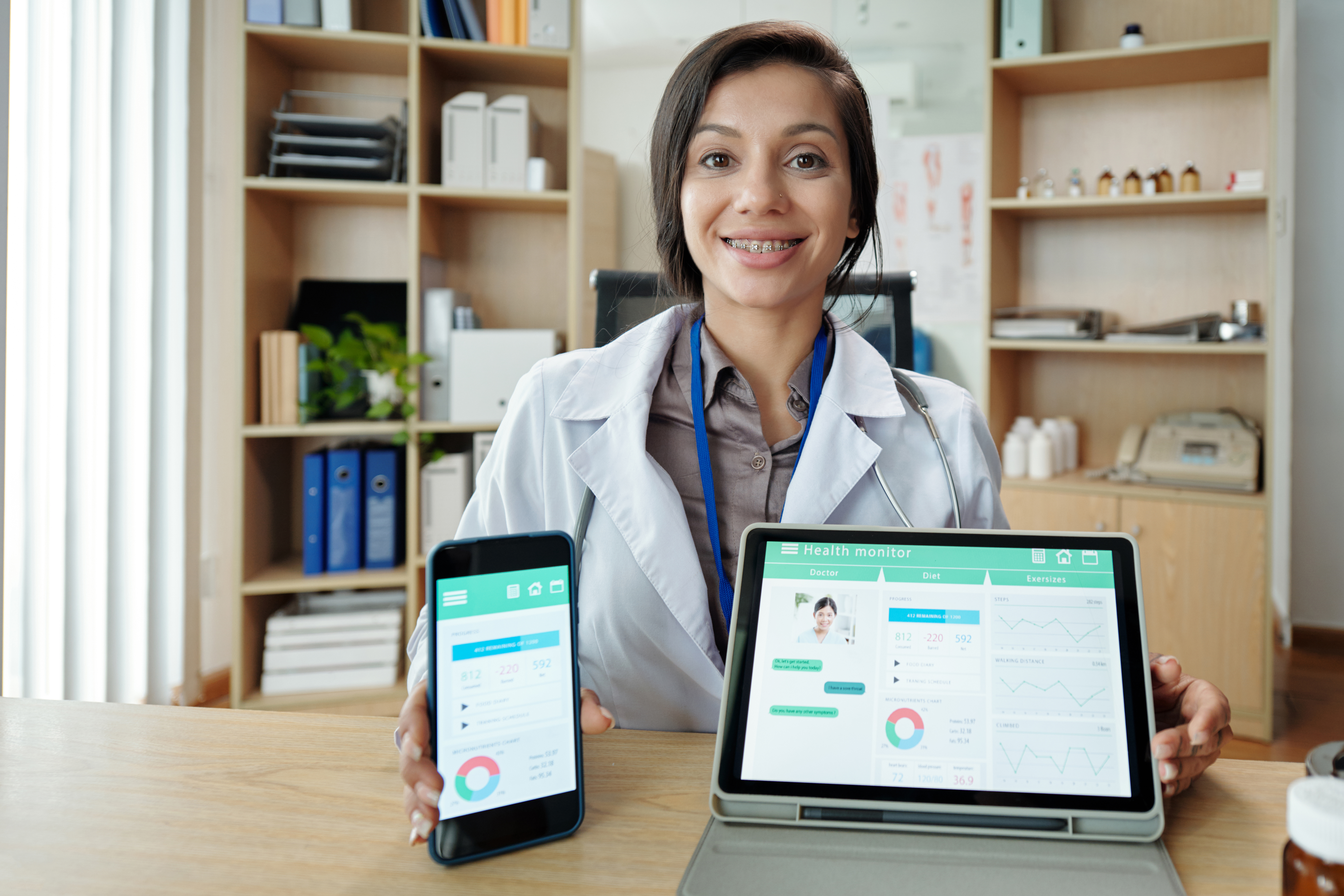 Doctor displaying health app interface, on the benefits of chatbots in healthcare​